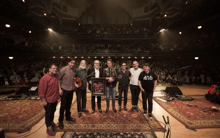 President & CEO of the Corporation of Massey Hall and Roy Thomson Hall, Deane Cameron, presents Blue Rodeo with the Massey Hall Honours Award on February 18, 2016 in Toronto. (Photo: Dustin Rabin)