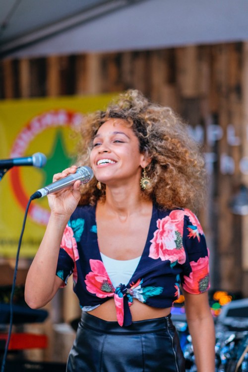Chris Martin of Coldplay and Izzy Bizu perform at The Wynwood Yard in Miami, Florida on August 27, 2017. (Photo: Andrea Lorena)