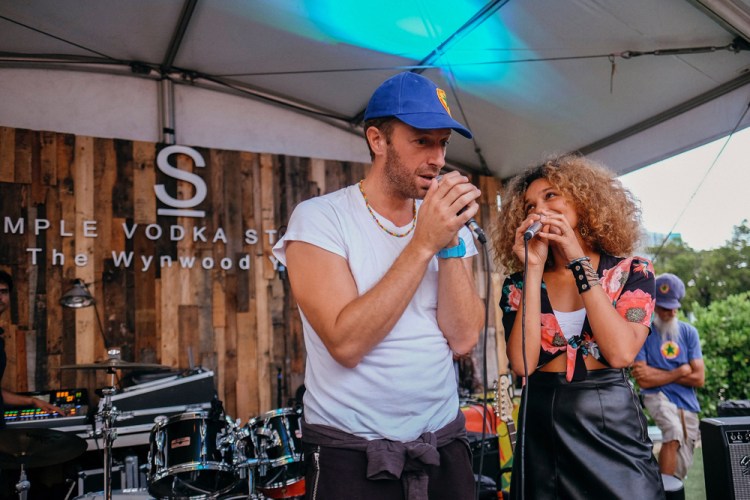 Chris Martin of Coldplay and Izzy Bizu perform at The Wynwood Yard in Miami, Florida on August 27, 2017. (Photo: Andrea Lorena)
