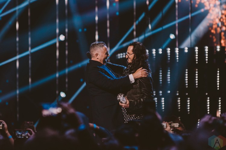 VANCOUVER, BC - MARCH 25: Ed Robertson of Barenaked Ladies and Geddy Lee of Rush embrace at the Juno Awards at Rogers Arena in Vancouver on March 25, 2018. (Photo: Tim Nugyen/Aesthetic Magazine)